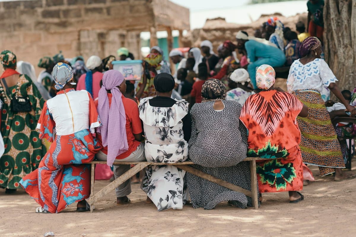 Women gathered outdoors in Ghana, shown as illustrative editorial photography