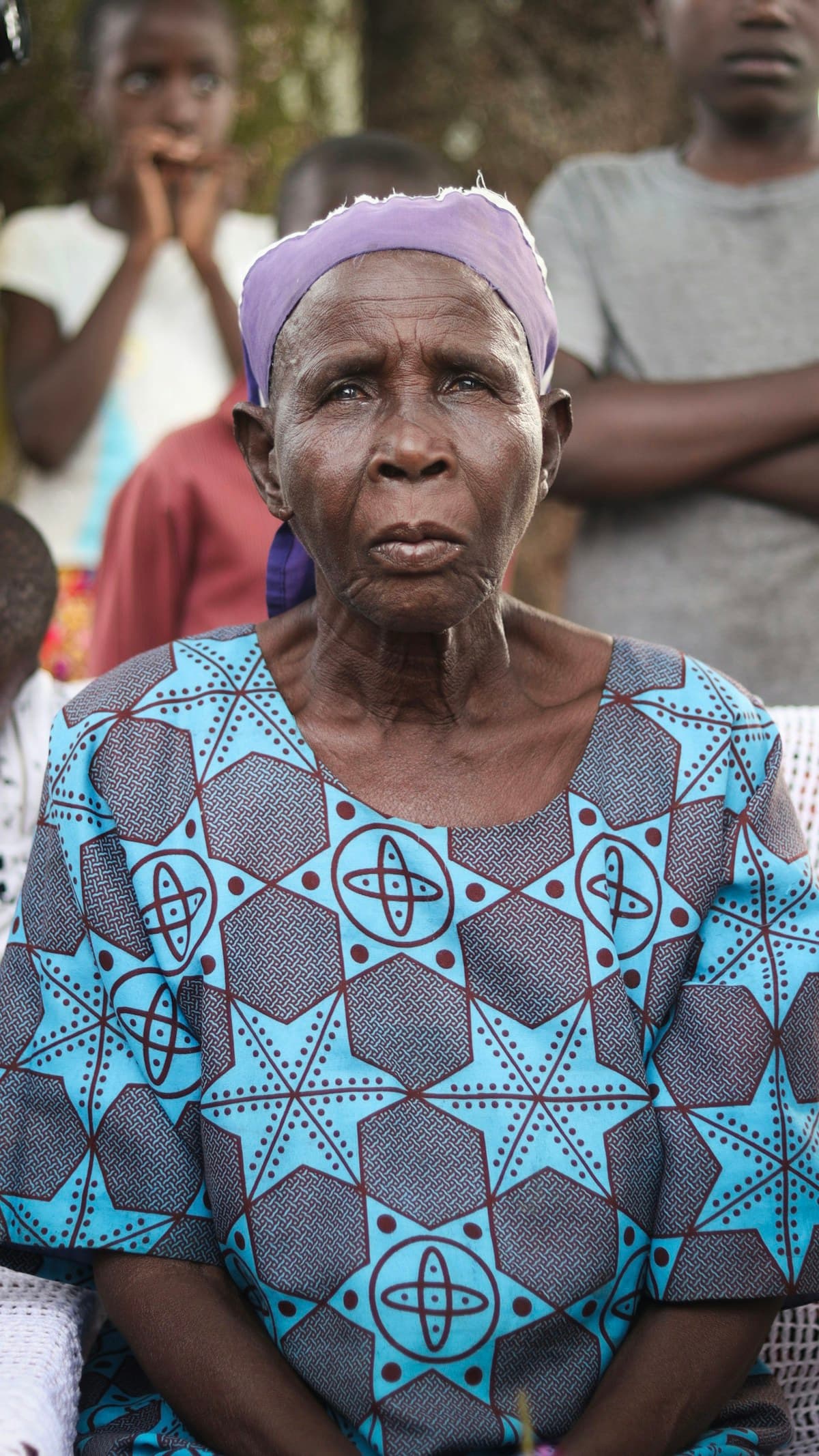 A community member listening during a gathering in Kisumu